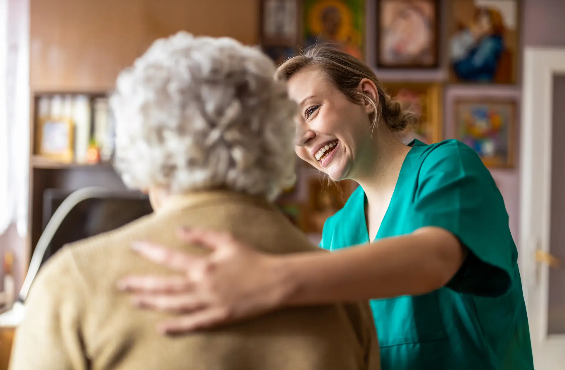 A caregiver greeting a resident at home