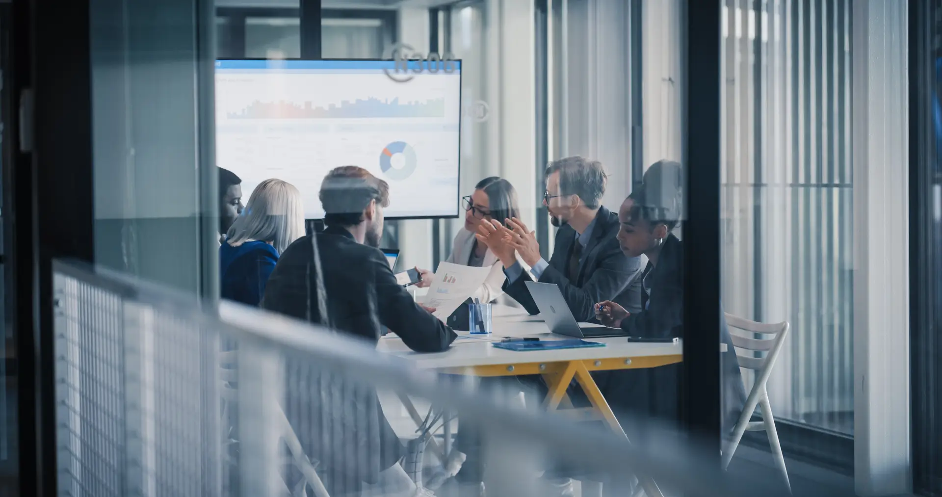 A leadership team reviewing growth figures on a shared screen