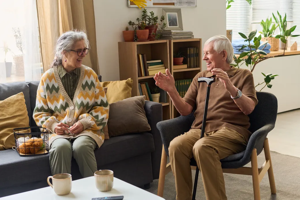 A couple talking on a sofa in a community lounge